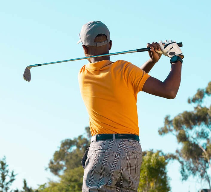 The back of a golfer just after a large swing