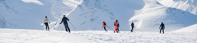 Skiers and snowboarders on mountain slopes