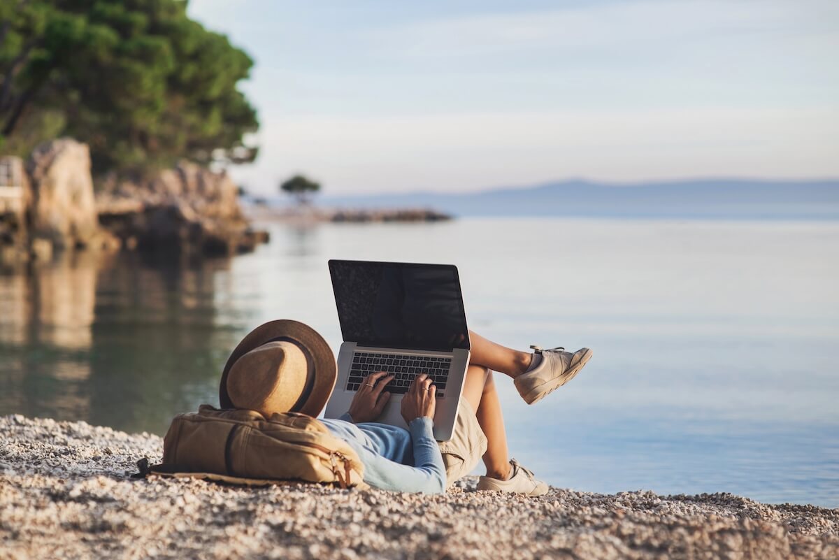 Customer on laptop by the beach