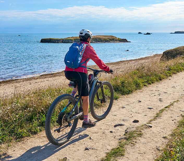 Cyclist riding near the beach