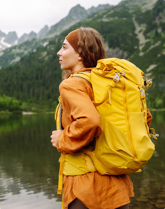 Girl hiking near forest lake