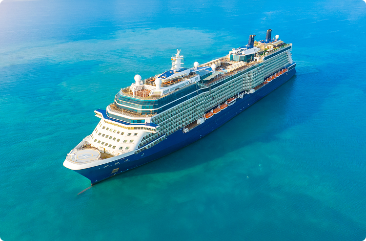 A lone cruise ship floats in calm blue water