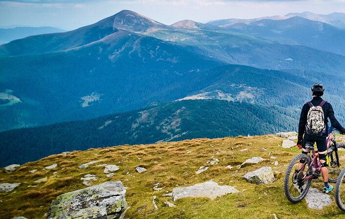 people riding mountain bikes down a path