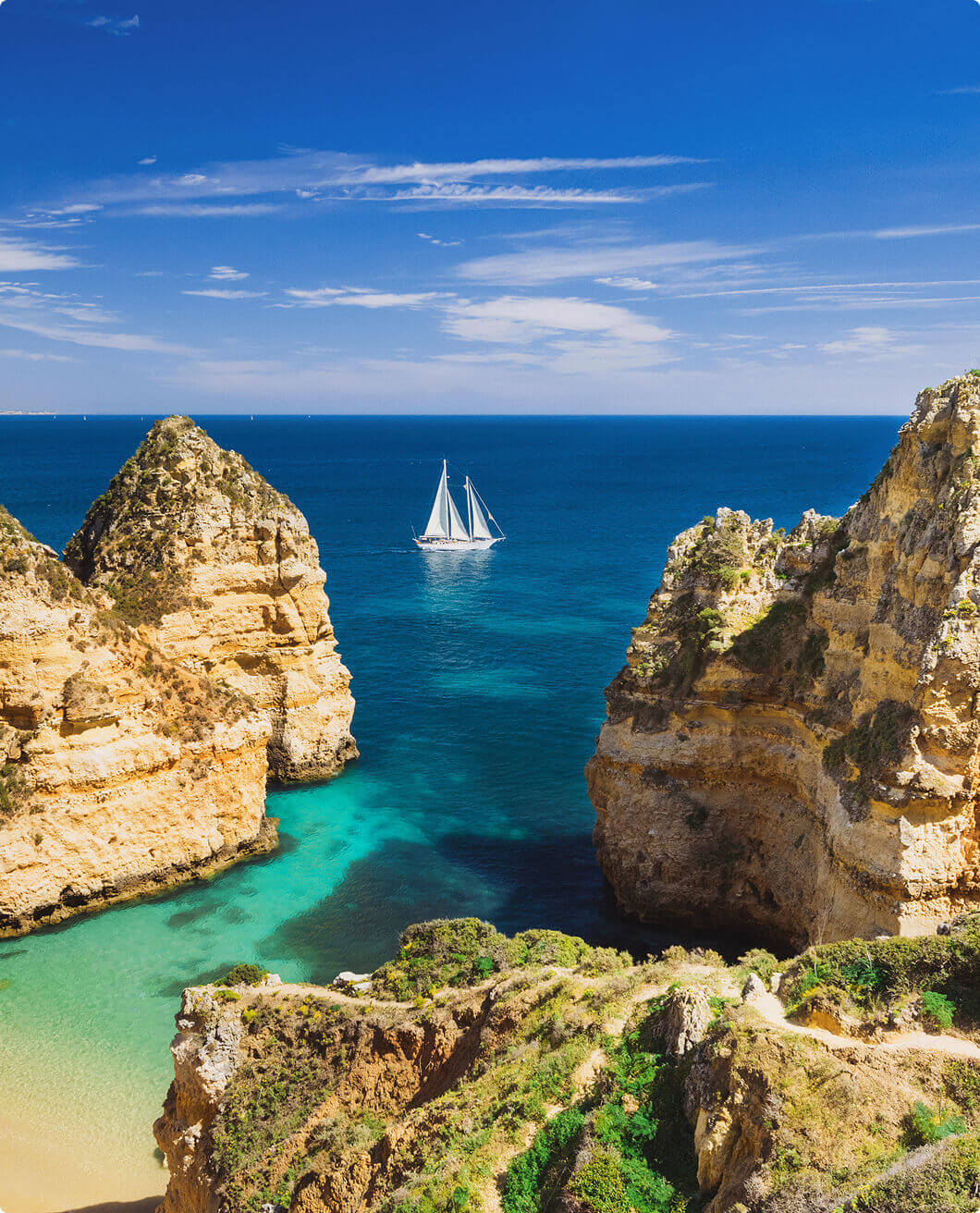 View of sailboat on water from cliff